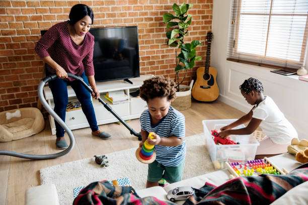 House cleaning services in Los Angeles helping families maintain a clean and organized home while children play in the living room.